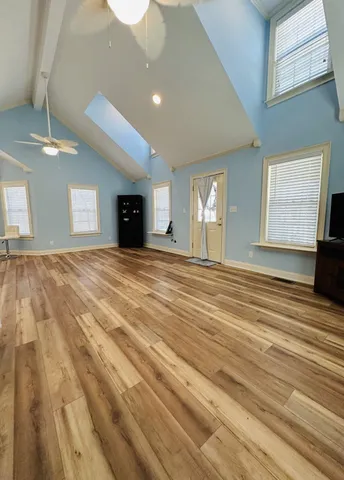 a view of an empty room with window and fireplace