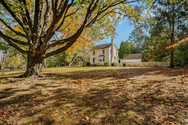 a view of a house with wooden fence