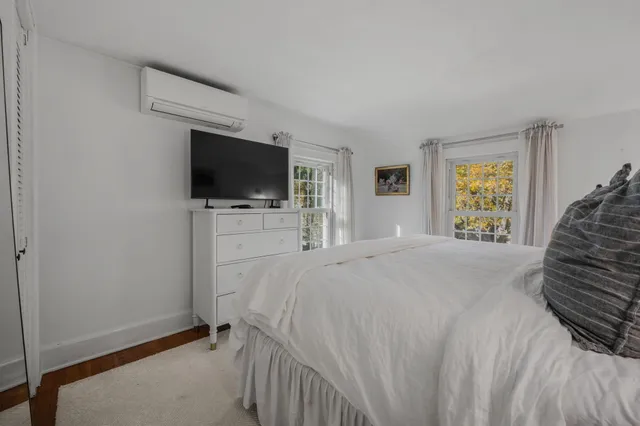 a bedroom with a bed and a painting on the wall