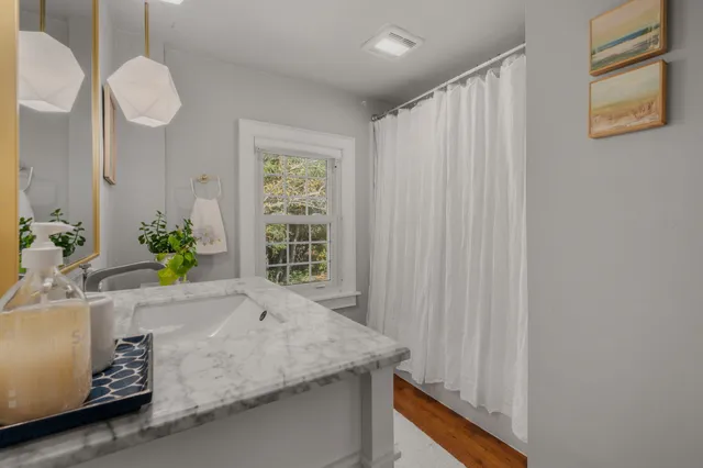 a bathroom with a granite countertop sink a vanity and a mirror