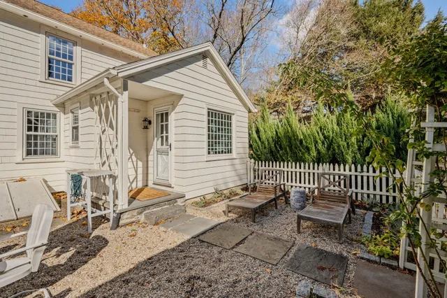 a view of a yard with plants and wooden fence