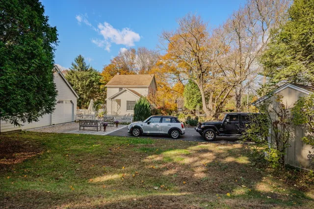 a view of a white house with a yard