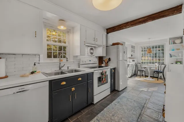 a kitchen with stainless steel appliances a stove and more cabinets