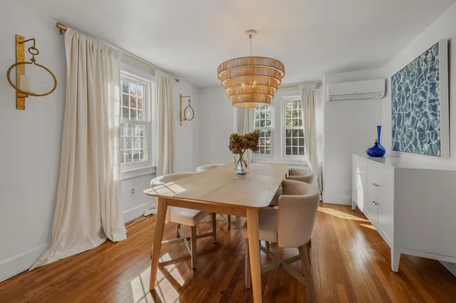 a view of a dining room with furniture window and wooden floor