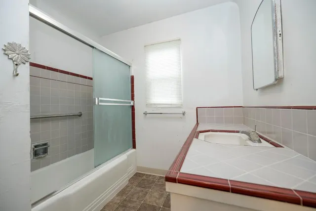 a bathroom with a bathtub and a shower