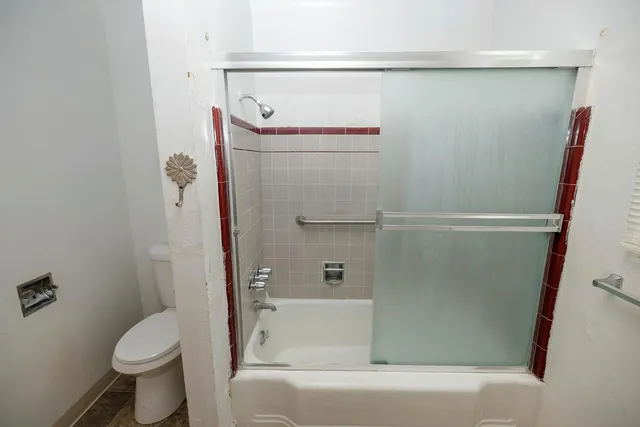 a bathroom with a shower and a toilet