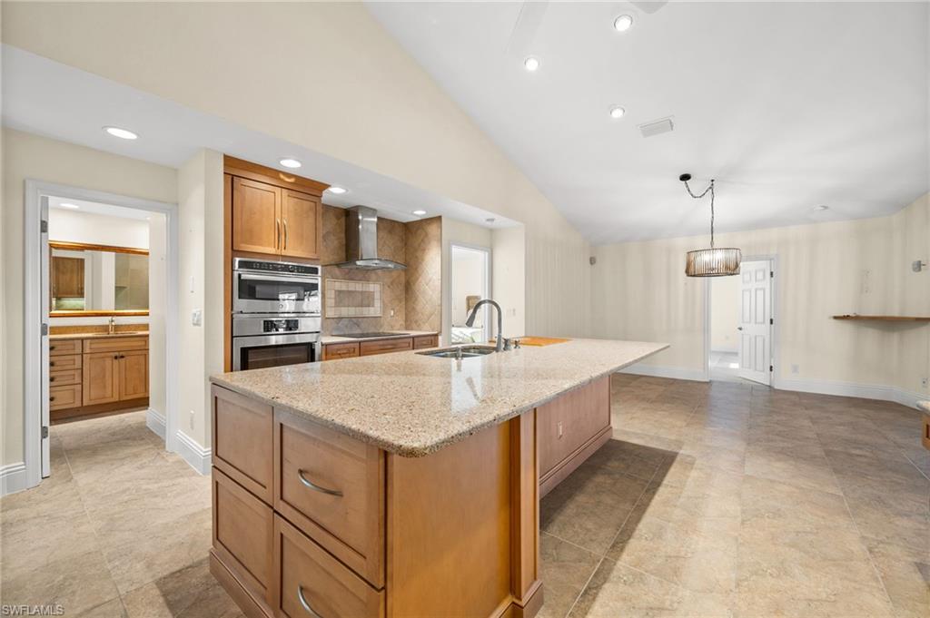 544 Roma Court Naples, FL 34110 - Photo 16 of 41 a kitchen with a sink stove and refrigerator