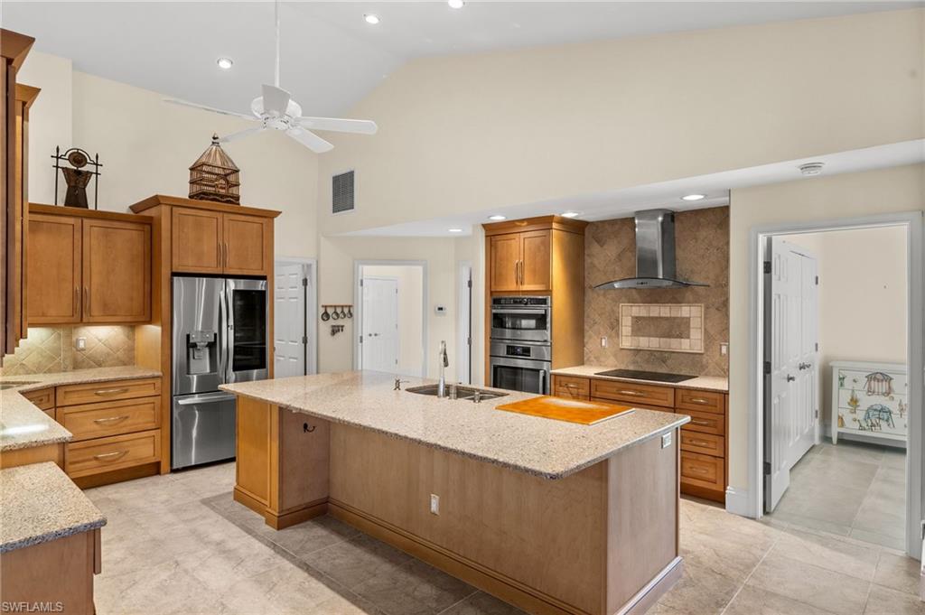544 Roma Court Naples, FL 34110 - Photo 18 of 41 a kitchen with stainless steel appliances granite countertop a refrigerator and a stove