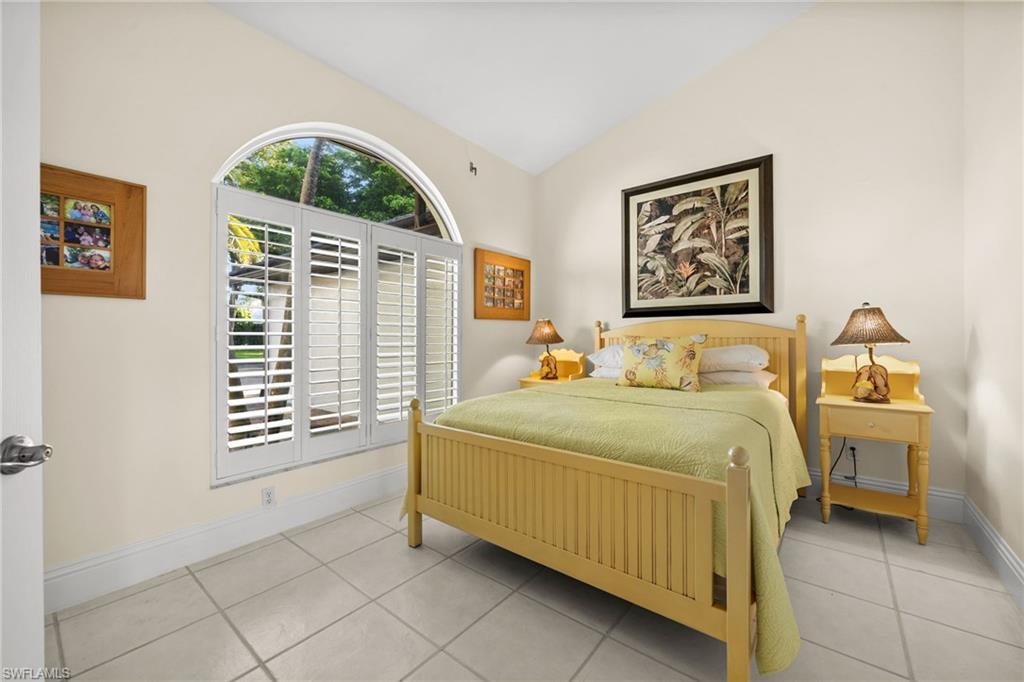 544 Roma Court Naples, FL 34110 - Photo 19 of 41 a bedroom with a bed and a window