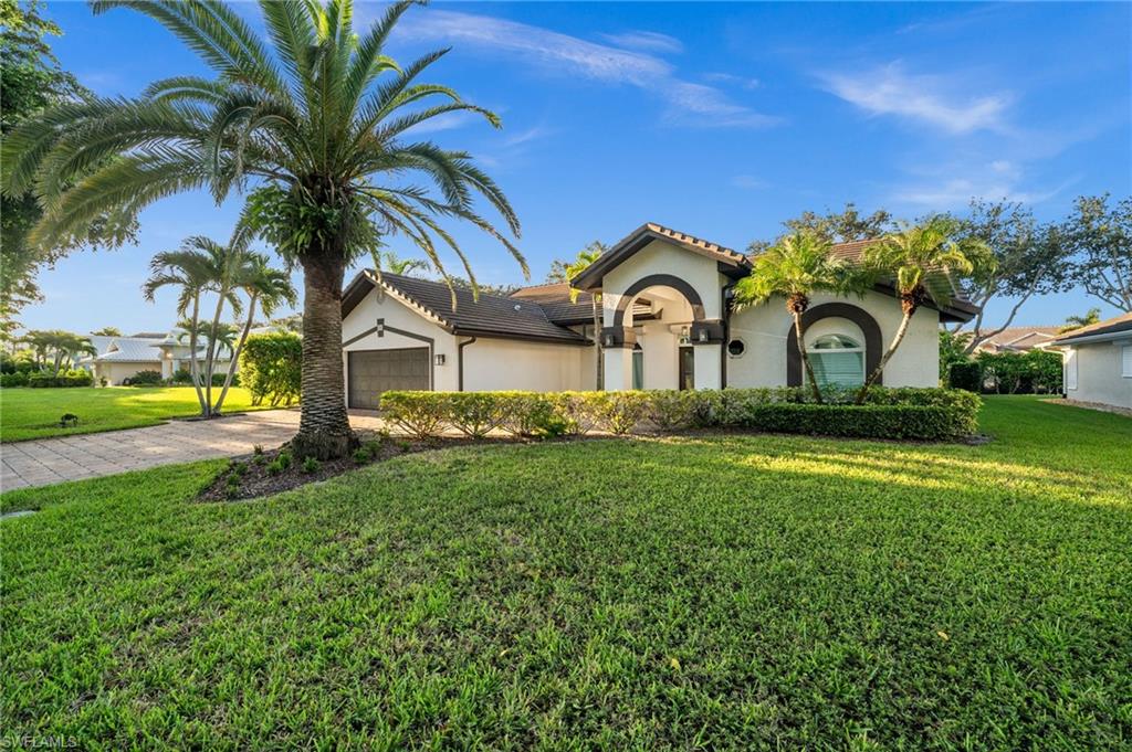 544 Roma Court Naples, FL 34110 - Photo 2 of 41 a front view of a house with garden