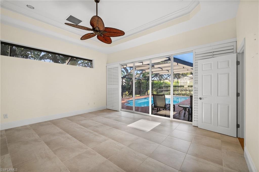 544 Roma Court Naples, FL 34110 - Photo 21 of 41 a living room with furniture and a floor to ceiling window
