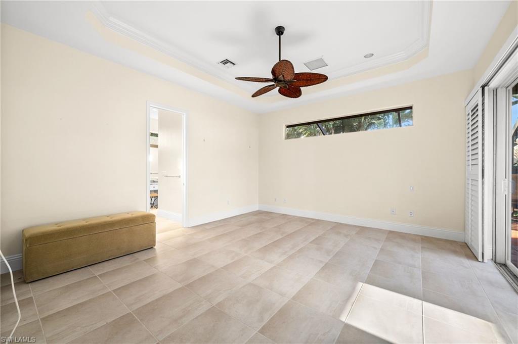 544 Roma Court Naples, FL 34110 - Photo 24 of 41 a view of room with a ceiling fan and window