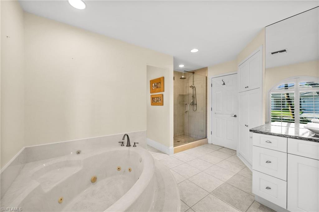 544 Roma Court Naples, FL 34110 - Photo 25 of 41 a bathroom with a bathtub and a sink