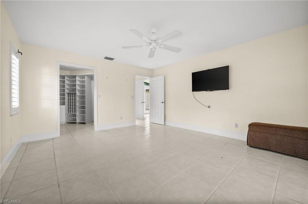 544 Roma Court Naples, FL 34110 - Photo 28 of 41 en empty room with ceiling fan and window