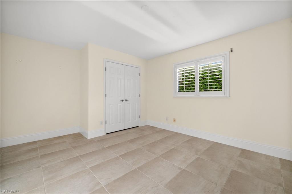 544 Roma Court Naples, FL 34110 - Photo 30 of 41 an empty room with a window