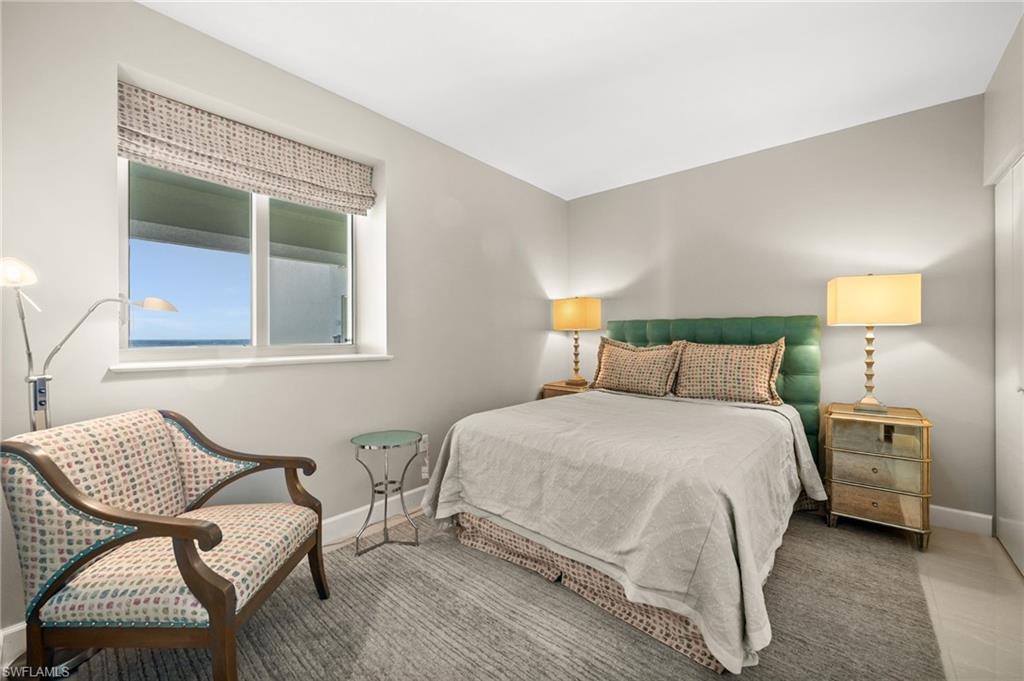 544 Roma Court Naples, FL 34110 - Photo 32 of 41 a bedroom with a bed and window