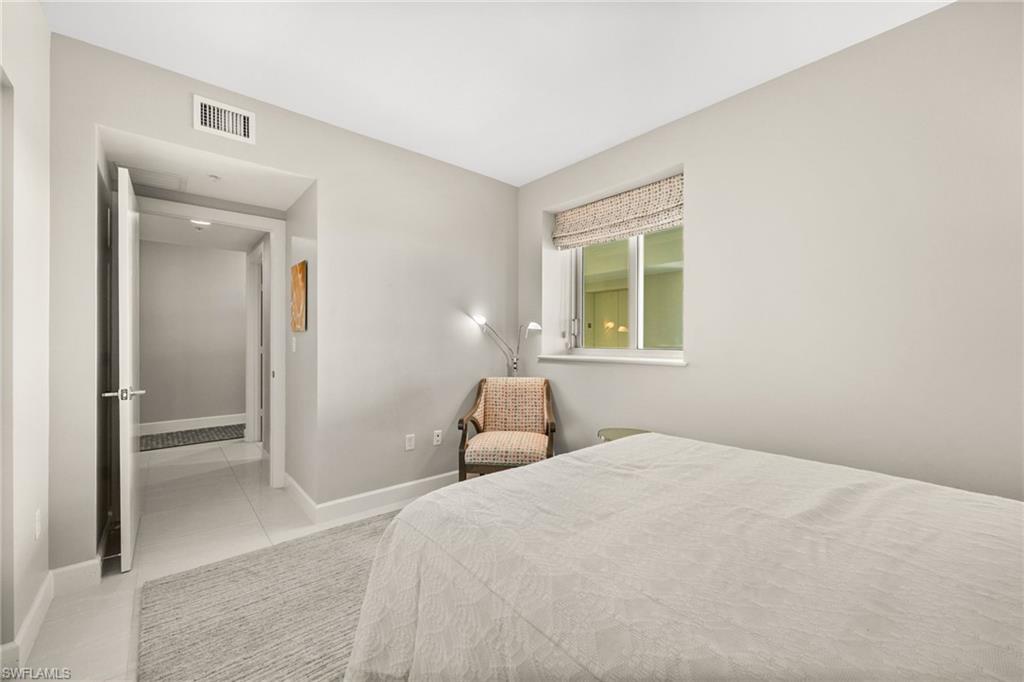 544 Roma Court Naples, FL 34110 - Photo 33 of 41 a bedroom with a bed and a window