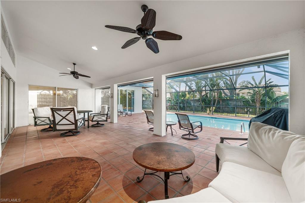 544 Roma Court Naples, FL 34110 - Photo 34 of 41 a dining room with furniture water view and a floor to ceiling window