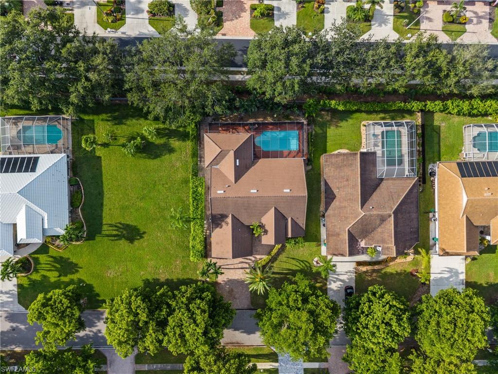 544 Roma Court Naples, FL 34110 - Photo 4 of 41 an aerial view of a house with outdoor space lake view and trees in the background