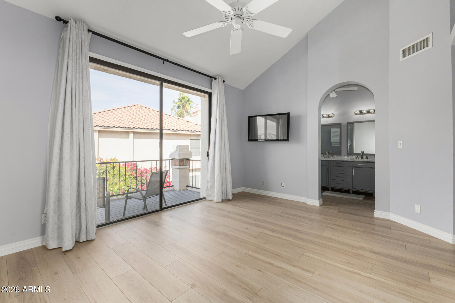 9705 East Mountain View Road, Unit 1126 Scottsdale, AZ 85258 - Photo 12 of 33 an empty room with wooden floor fan and windows