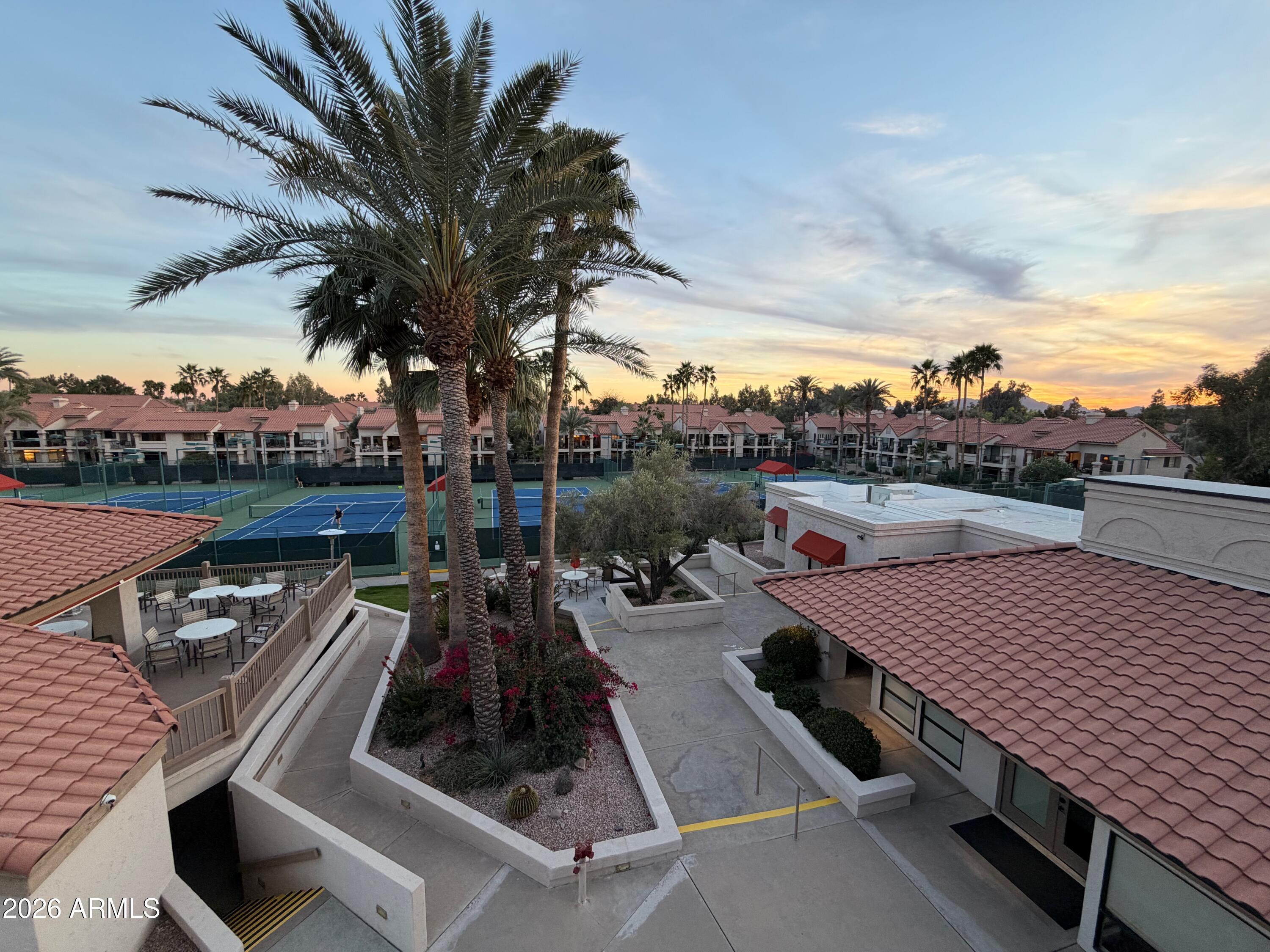 9705 East Mountain View Road, Unit 1126 Scottsdale, AZ 85258 - Photo 19 of 33 a view of a roof deck with couches and wooden floor