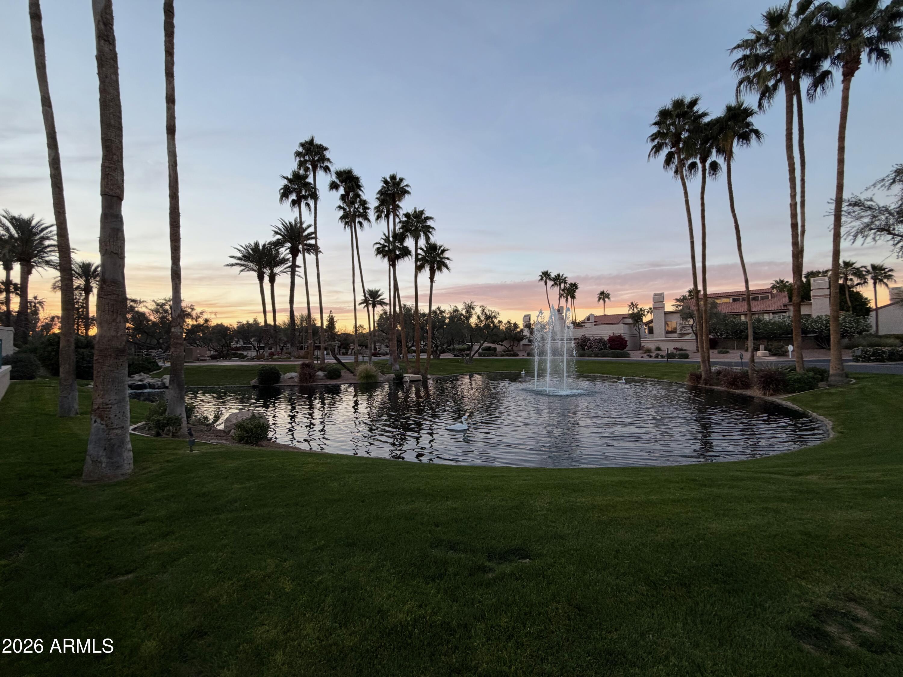 9705 East Mountain View Road, Unit 1126 Scottsdale, AZ 85258 - Photo 23 of 33 a view of a swimming pool with a garden