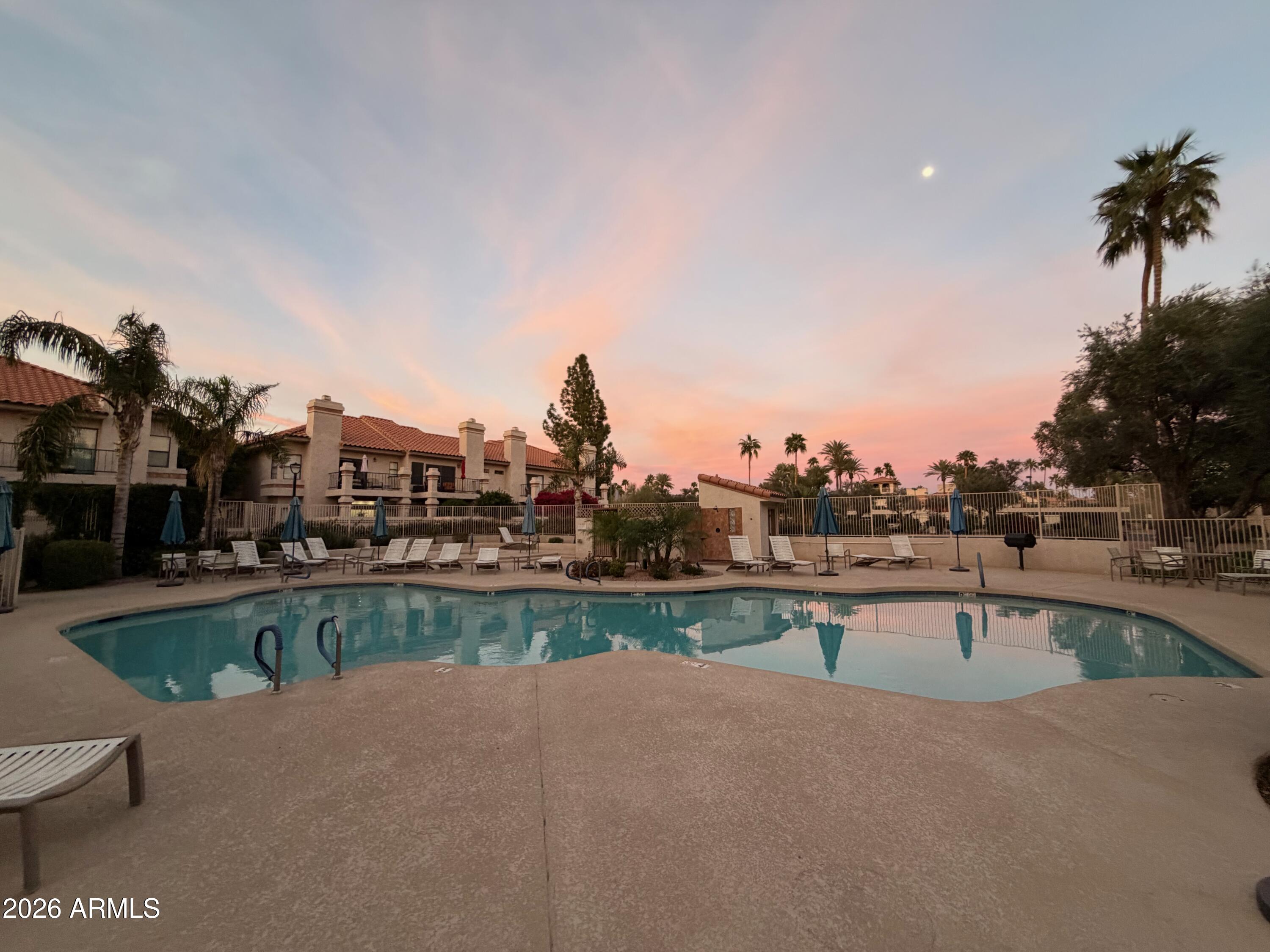 9705 East Mountain View Road, Unit 1126 Scottsdale, AZ 85258 - Photo 26 of 33 a view of a swimming pool and a terrace