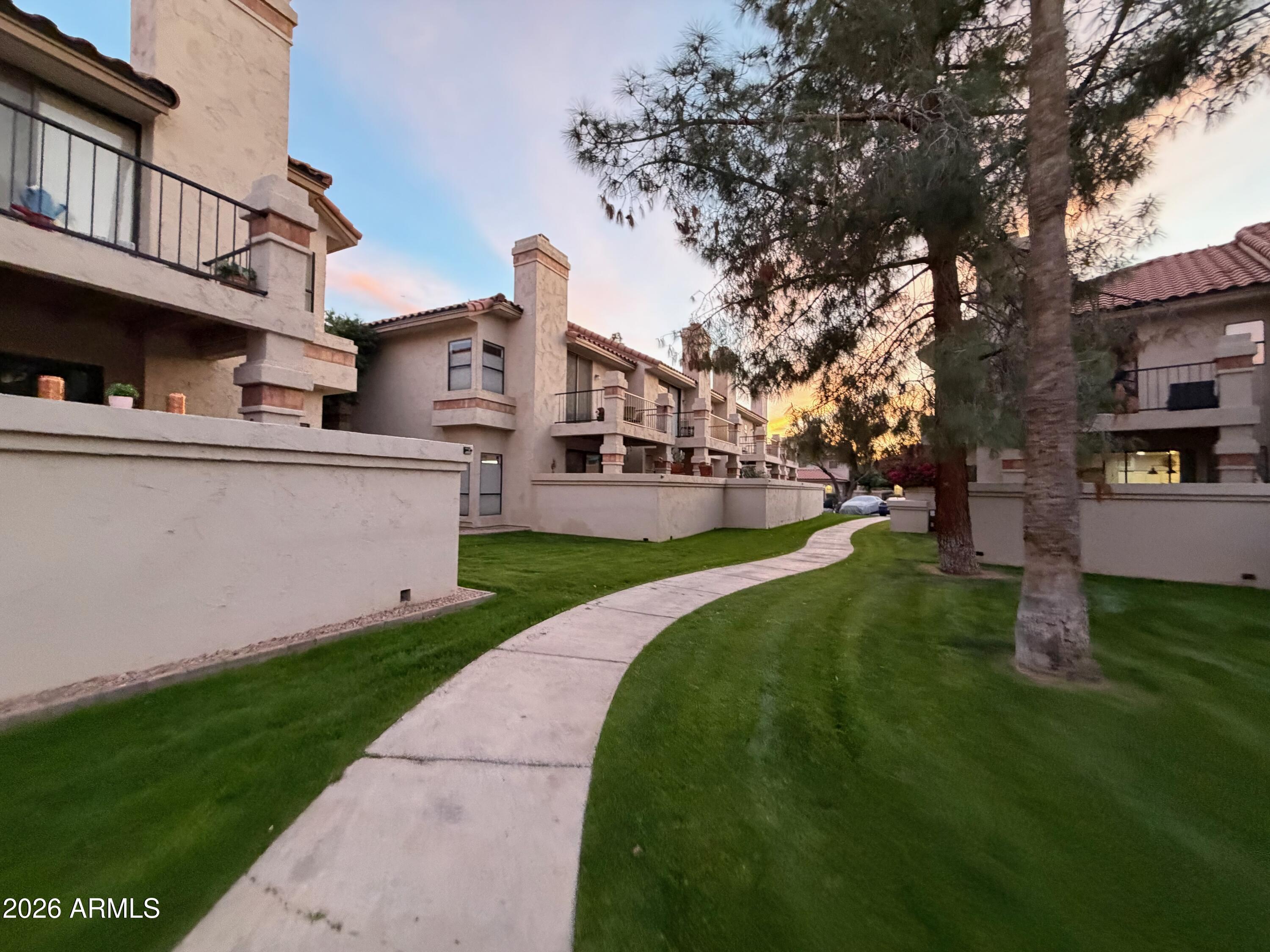 9705 East Mountain View Road, Unit 1126 Scottsdale, AZ 85258 - Photo 28 of 33 a front view of multiple houses with yard