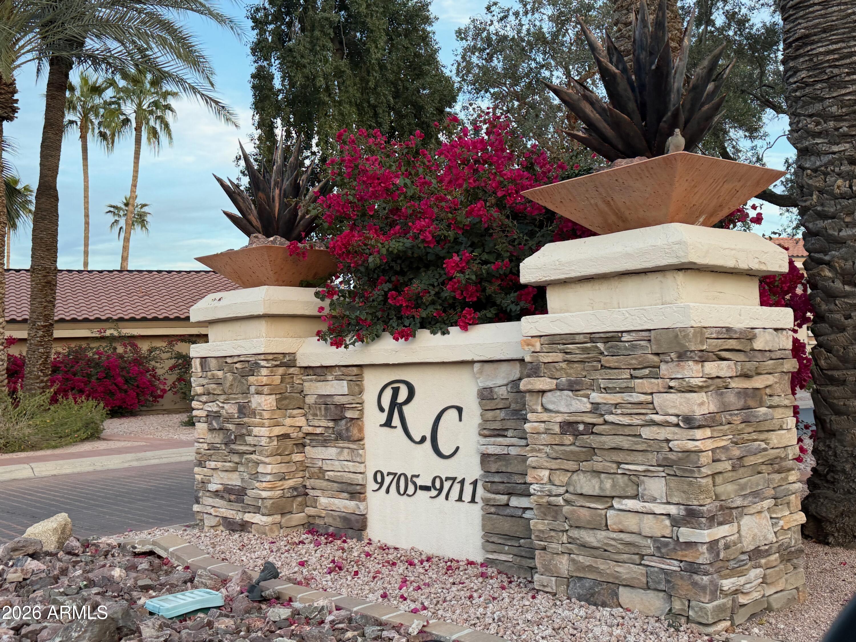 9705 East Mountain View Road, Unit 1126 Scottsdale, AZ 85258 - Photo 30 of 33 a sign that is sitting in front of flowers