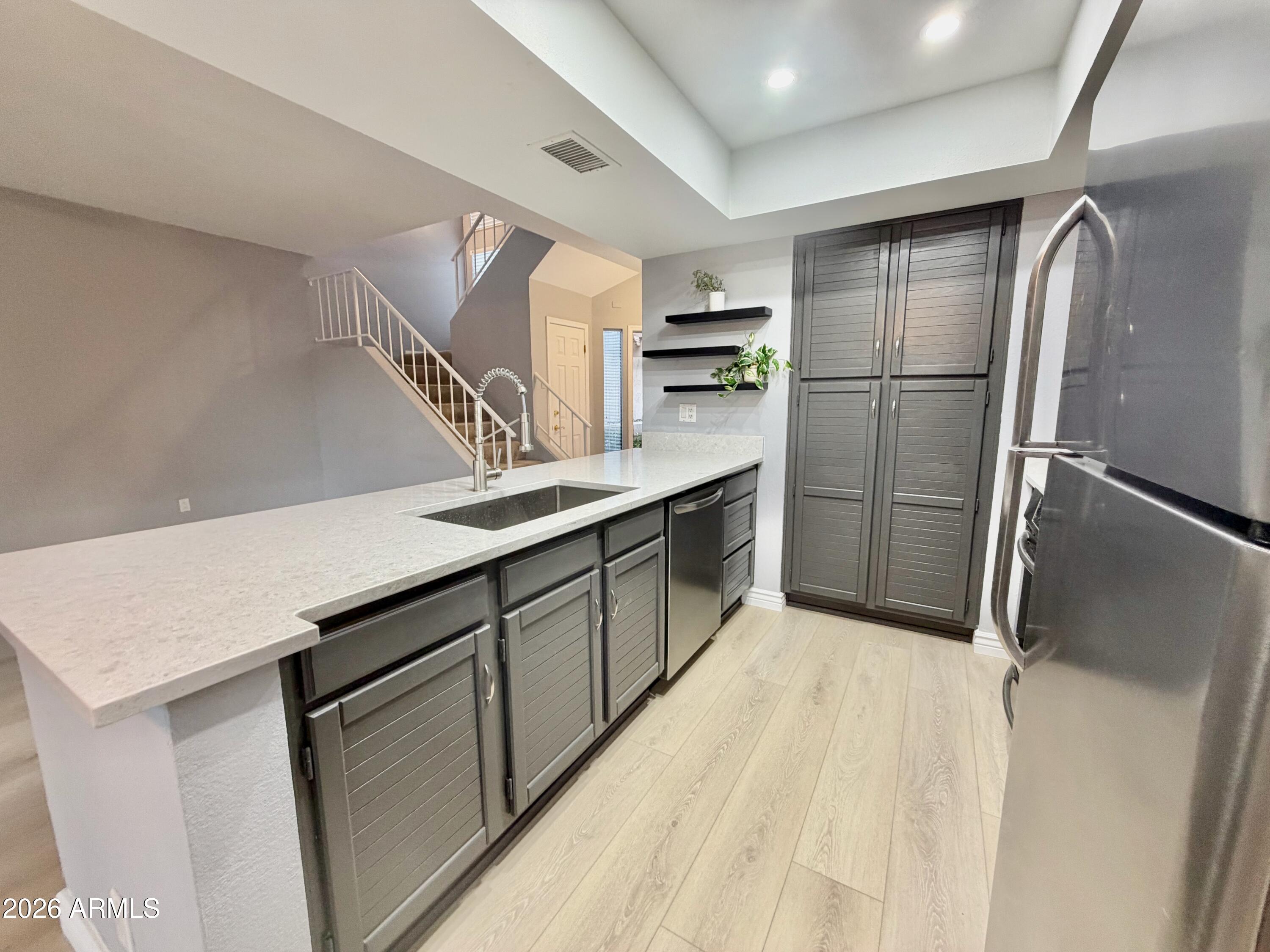 9705 East Mountain View Road, Unit 1126 Scottsdale, AZ 85258 - Photo 5 of 33 a kitchen with stainless steel appliances a refrigerator and a sink