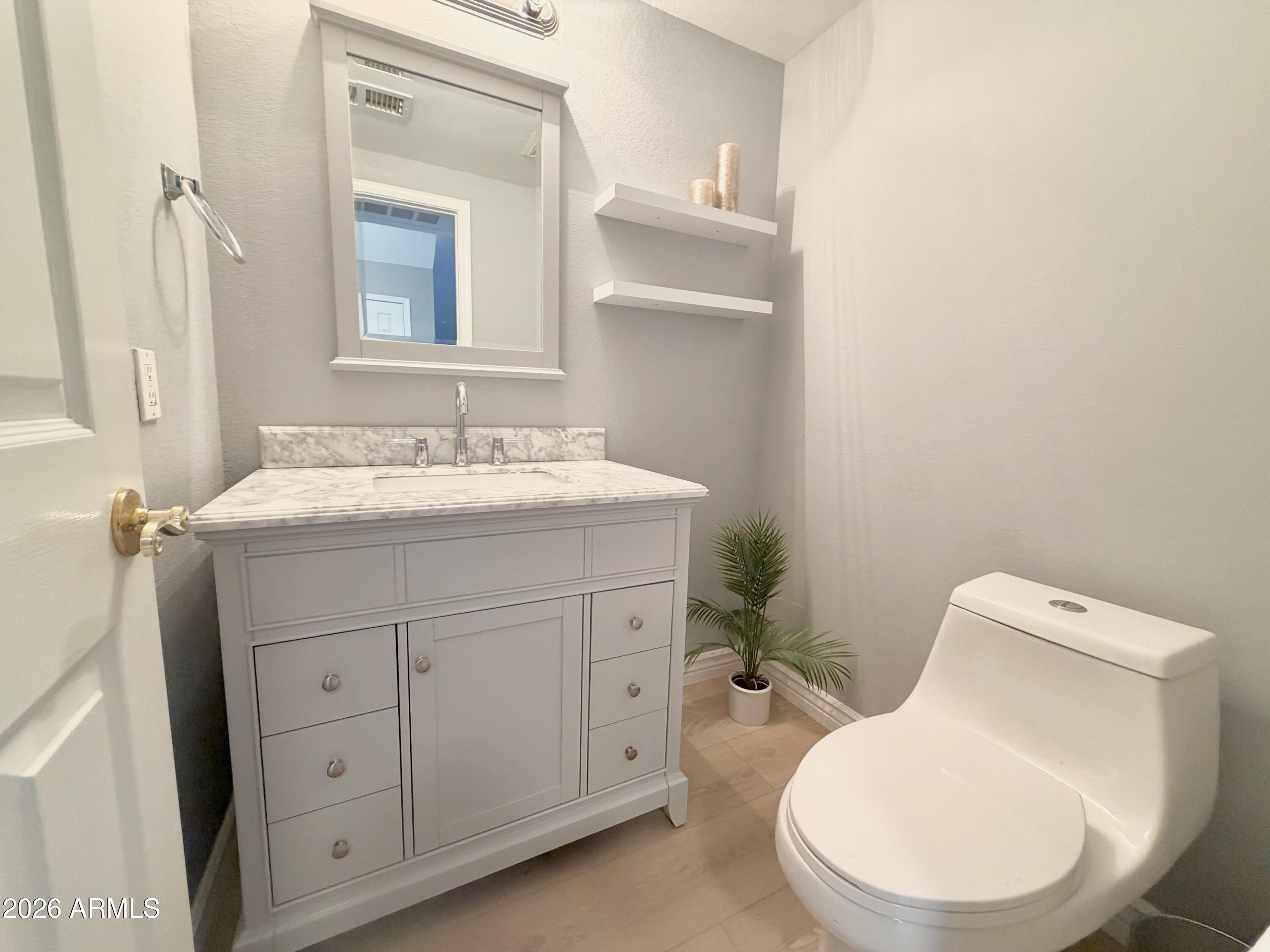 9705 East Mountain View Road, Unit 1126 Scottsdale, AZ 85258 - Photo 8 of 33 a bathroom with a toilet sink and mirror