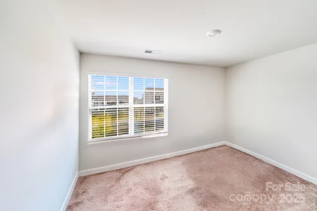 a view of a bedroom with window and gate