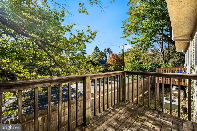 a view of empty room with window and ceiling fan
