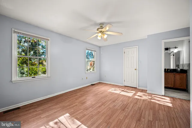 a view of an empty room and wooden floor