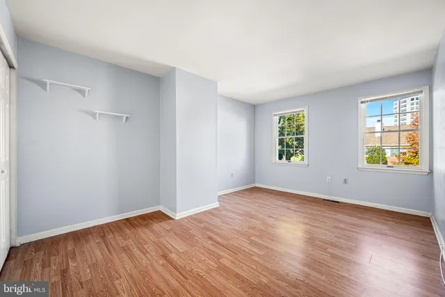 a view of an empty room with wooden floor