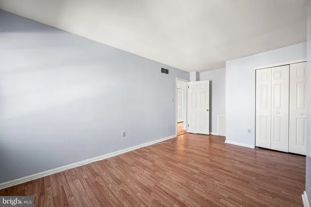 a view of an entryway with wooden floor and door
