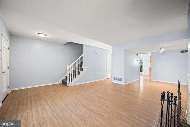 a view of empty room with wooden floor