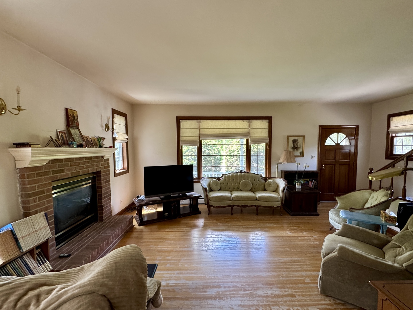 933 Harms Road Glenview, IL 60025 - Photo 7 of 25 a living room with furniture flat screen tv and a fireplace