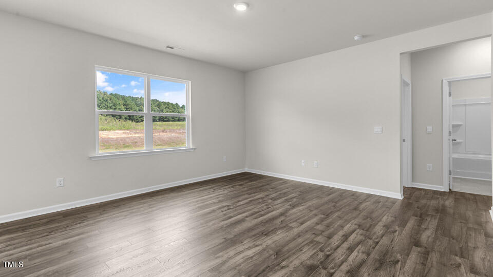 72 Westerly Way Lillington, NC 27546 - Photo 13 of 36 an empty room with wooden floor and windows
