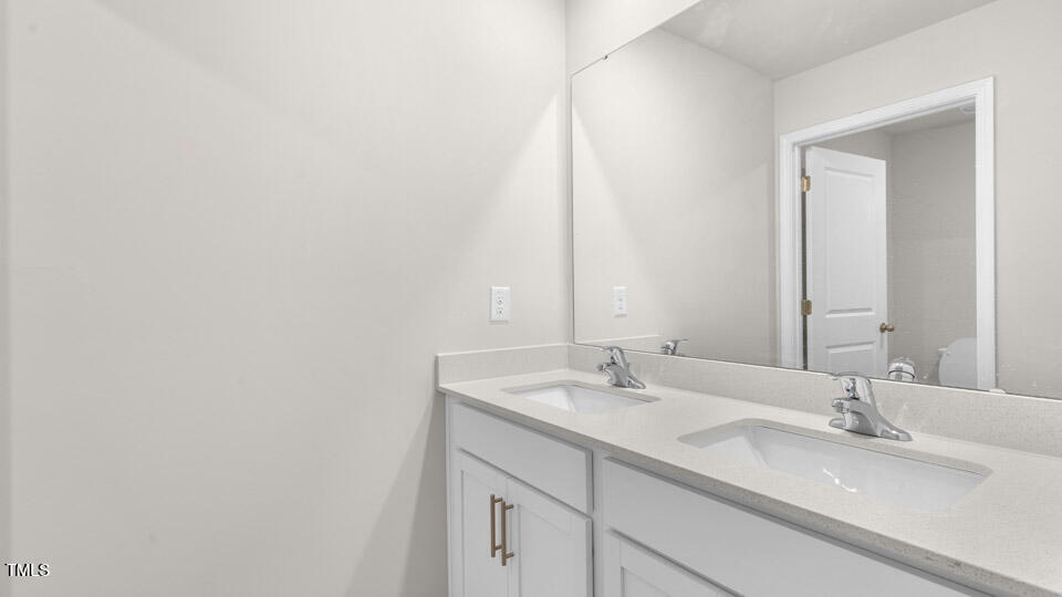 72 Westerly Way Lillington, NC 27546 - Photo 30 of 36 a bathroom with a double vanity sink and a mirror