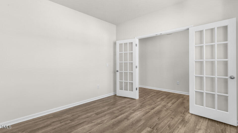 72 Westerly Way Lillington, NC 27546 - Photo 3 of 36 an empty room with wooden floor and empty shelves