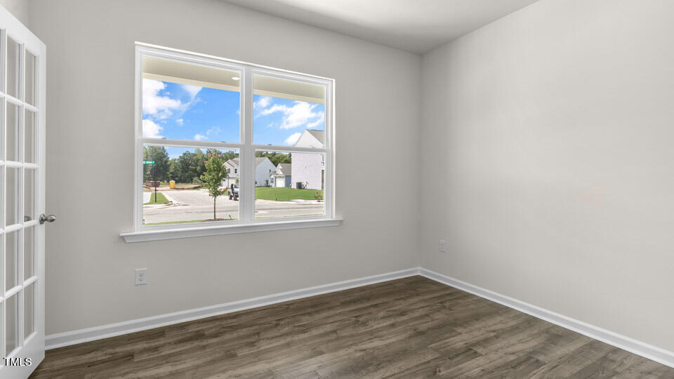 72 Westerly Way Lillington, NC 27546 - Photo 4 of 36 an empty room with wooden floor and windows