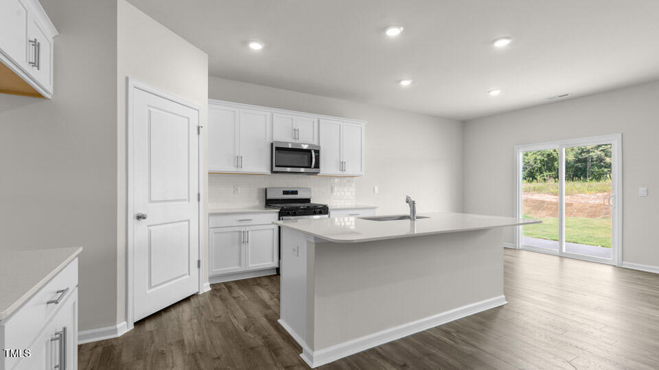 72 Westerly Way Lillington, NC 27546 - Photo 5 of 36 a kitchen with kitchen island granite countertop appliances cabinets and a sink