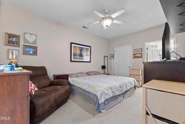 a bedroom with a bed couch and a window