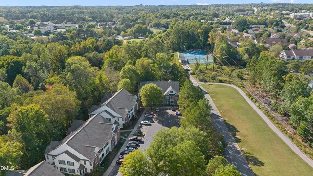 an aerial view of a house with a yard and lake view
