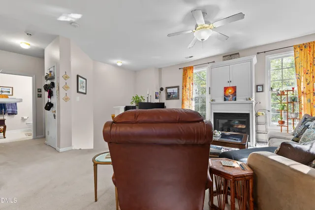 a living room with furniture a fireplace and a large window