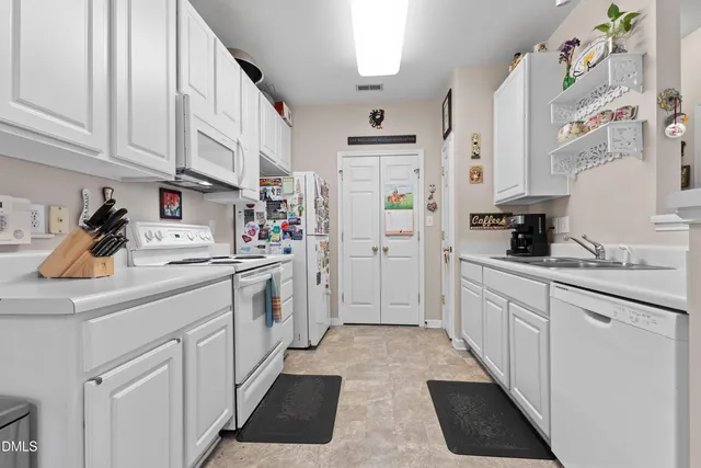 a kitchen with stainless steel appliances white cabinets and a sink