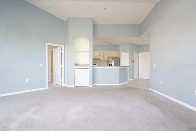 a view of a kitchen with a sink and a refrigerator