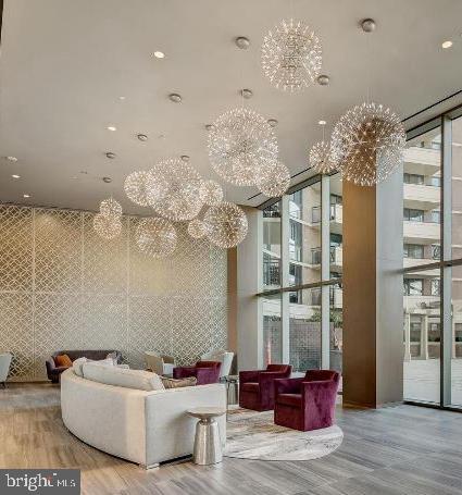 4620 North Park Avenue, Unit 1109E Chevy Chase, MD 20815 - Photo 3 of 5 a living room with furniture and chandelier