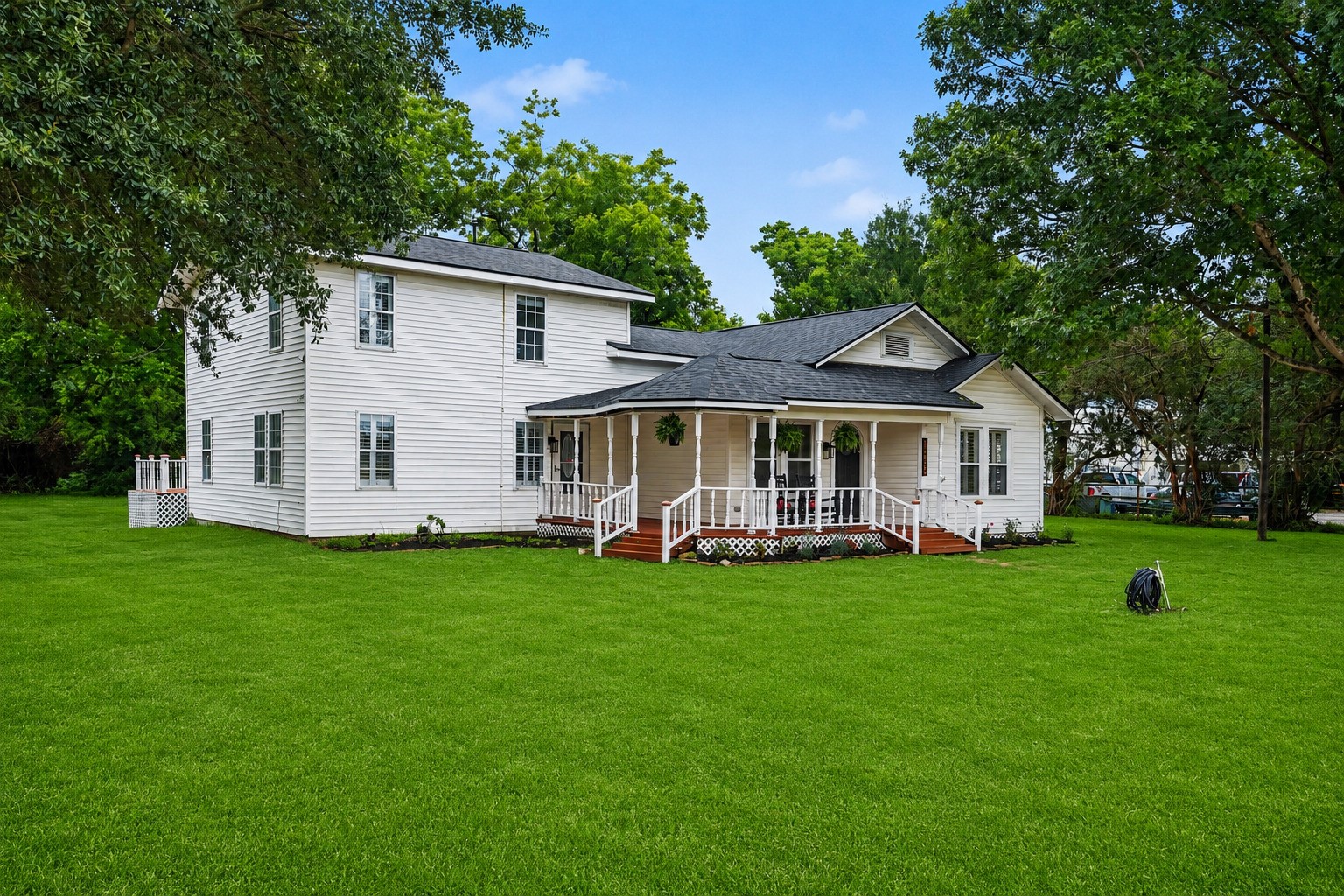 31730 Waller Tomball Road Waller, TX 77484 - Photo 7 of 50 Charming two-story white house with a welcoming front porch, ideal for those seeking a cozy, picturesque home setting.